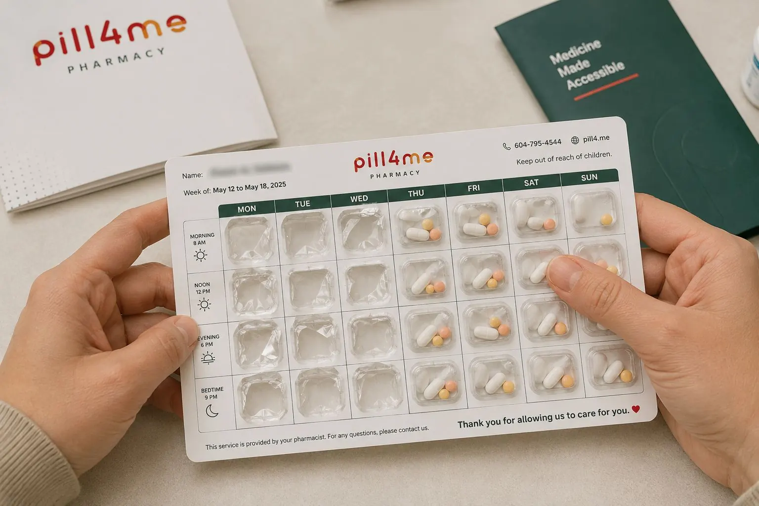 Hands holding a Pill4Me weekly blister pack, its pockets labelled Monday to Sunday across morning, noon, evening and bedtime rows.